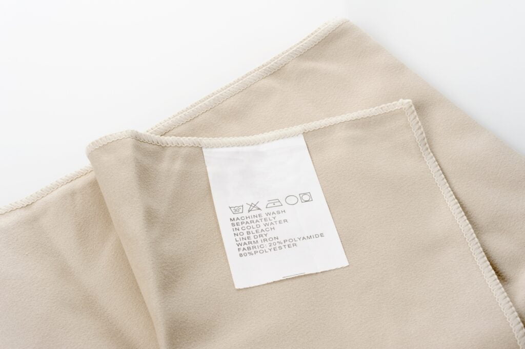 A Light-brown clothe with washing instructions.