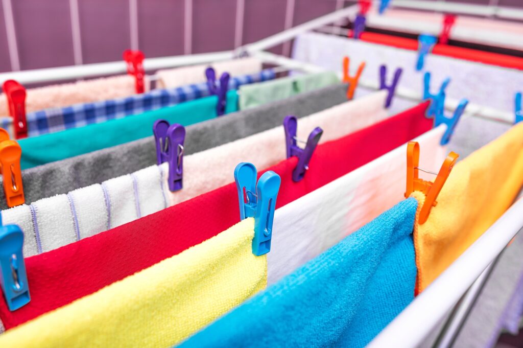 Many coloured clothes, drying after a wash.